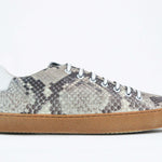 Side profile of low top python skin sneaker. Full snake skin upper and honey coloured rubber sole.