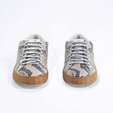 Front view of low top python skin sneaker. Full snake skin upper and honey coloured rubber sole.
