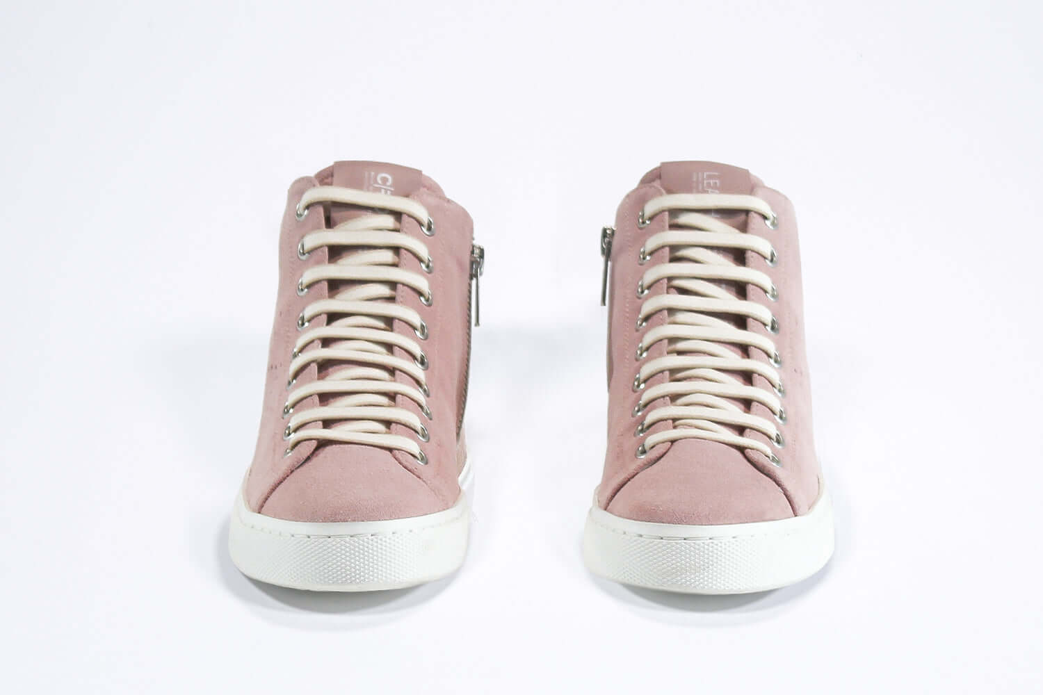 Front view of mid top sneaker in pink suede and leather upper, internal zip and white sole.