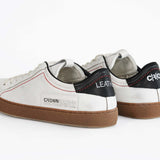 Vista posteriore della sneaker  BASSE bianca con accenti neri. Tomaia in pelle bianca invecchiata con cuciture rosse e suola in gomma scura.
