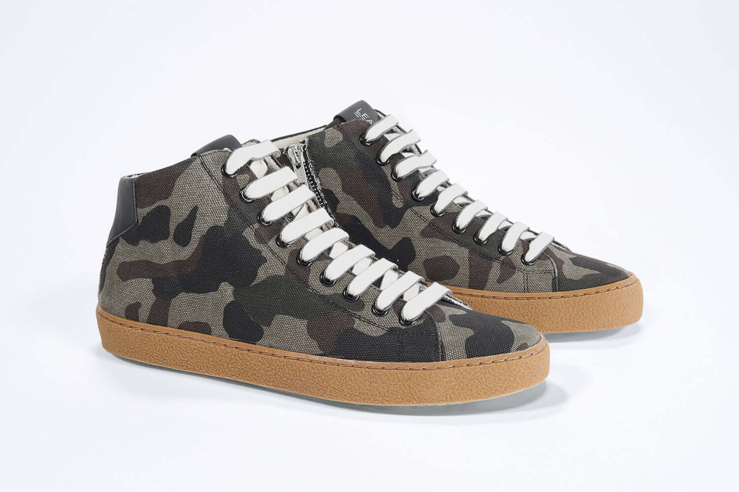 Three quarter front view of mid top camouflage print sneaker in canvas, internal zip and honey coloured sole.