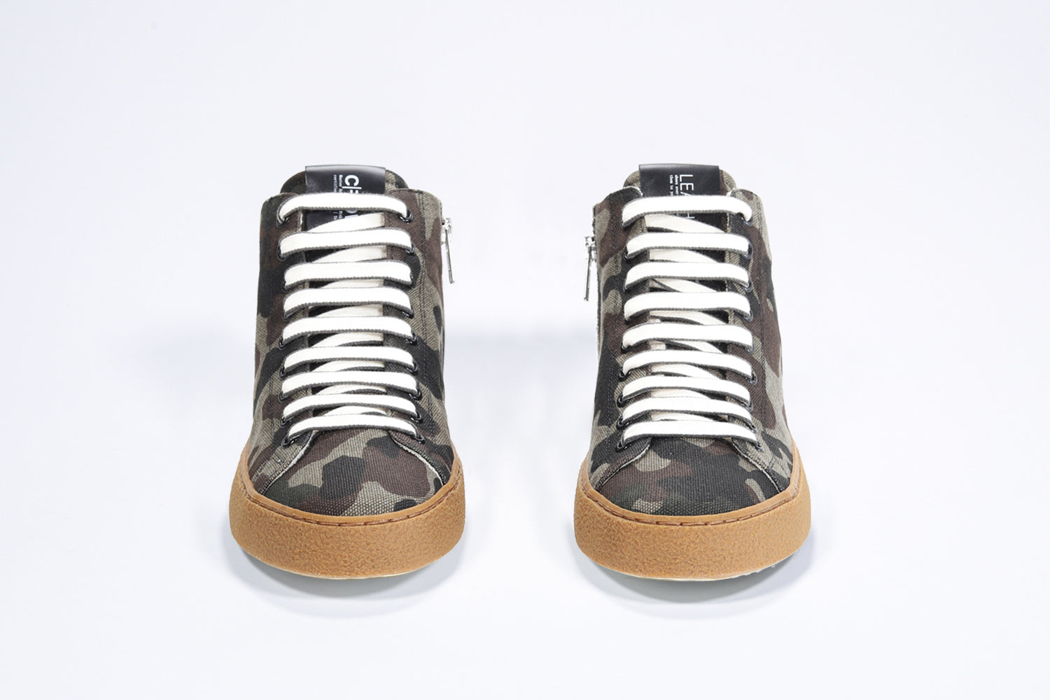 Front view of mid top camouflage print sneaker in canvas, internal zip and honey coloured sole.