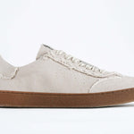 Side view of low top retro sneaker in distressed stone canvas, with honey coloured recycled rubber sole.