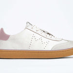 Side view of low top retro sneaker in distressed white leather with peach detailing and honey coloured recycled rubber sole.