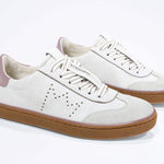 Three quarter front view of low top retro sneaker in distressed white leather with peach detailing and honey coloured recycled rubber sole.