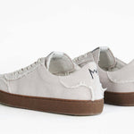 Back view of low top retro sneaker in distressed stone canvas, with honey coloured recycled rubber sole.