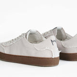 Back view of low top retro sneaker in distressed stone canvas, with honey coloured recycled rubber sole.