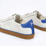 Back view of low top retro sneaker in distressed white leather with blue detailing and honey coloured recycled rubber sole.