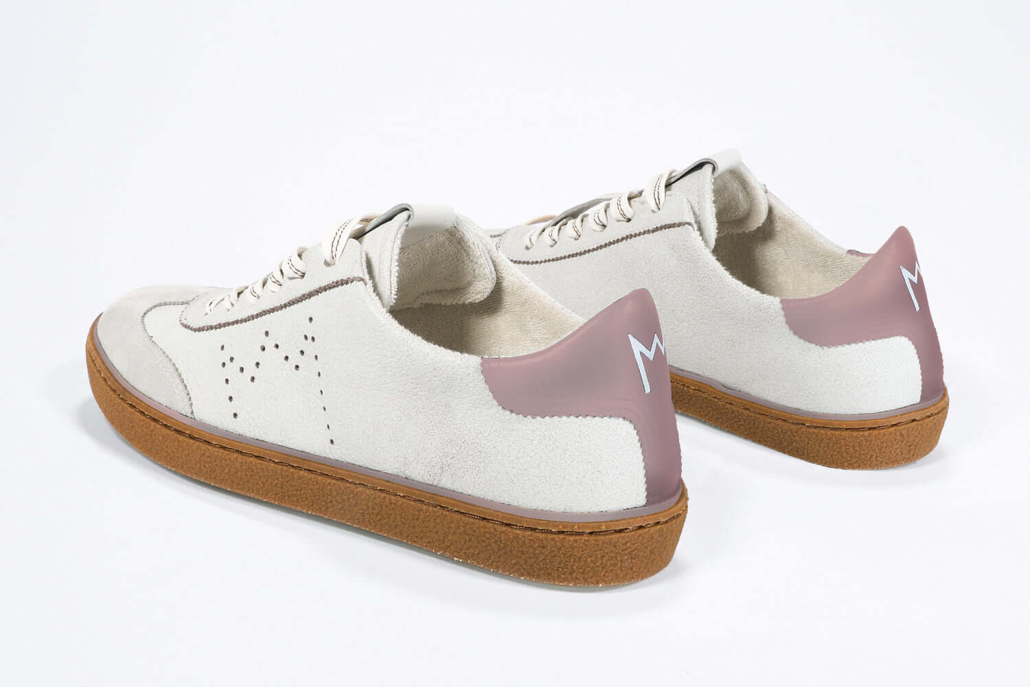 Back view of low top retro sneaker in distressed white leather with peach detailing and honey coloured recycled rubber sole.