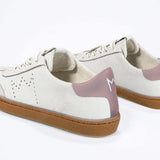 Back view of low top retro sneaker in distressed white leather with peach detailing and honey coloured recycled rubber sole.