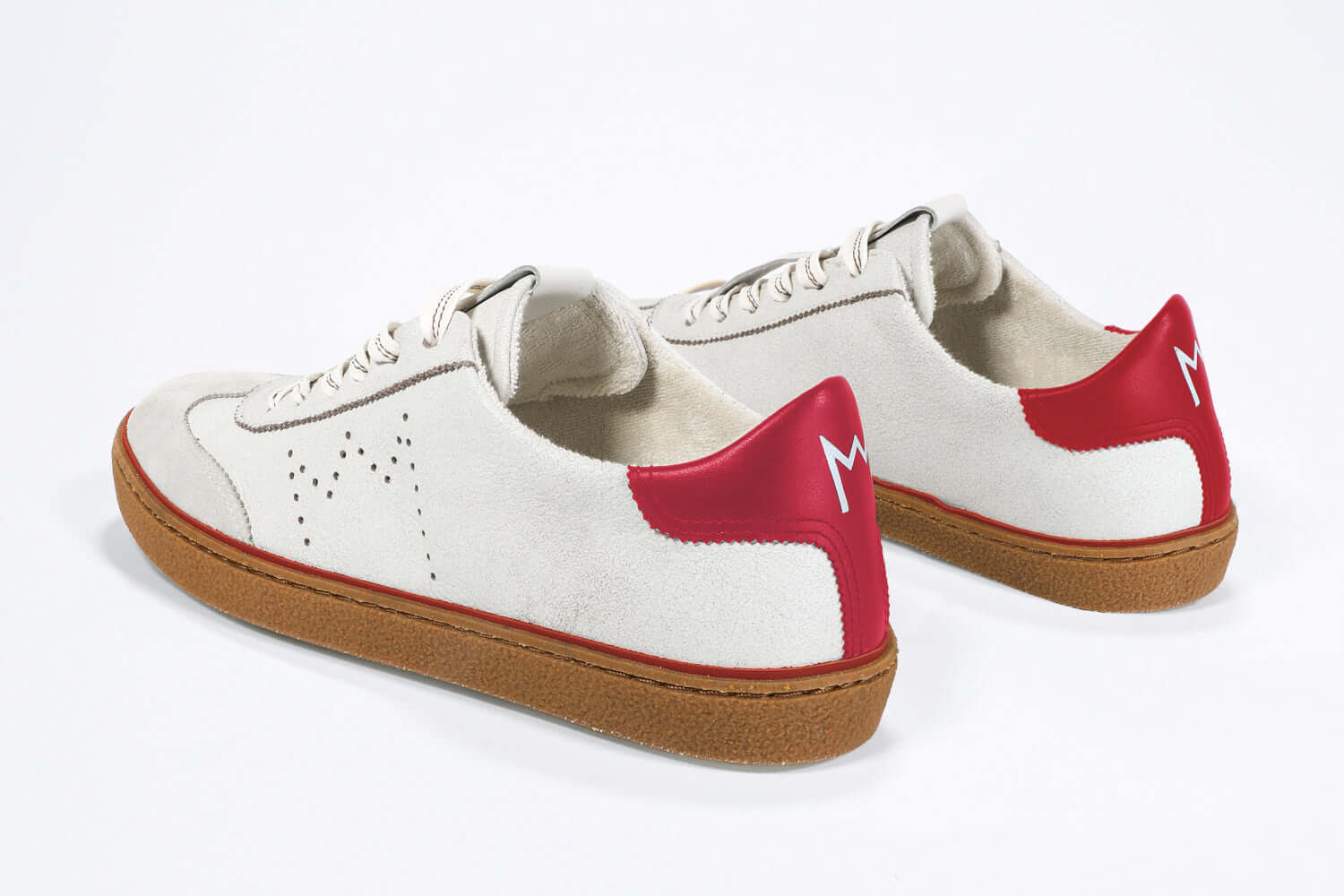 Back view of low top retro sneaker in distressed white leather with red detailing and honey coloured recycled rubber sole.