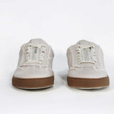 Front view of low top retro sneaker in distressed stone canvas, with honey coloured recycled rubber sole.