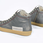 Back view of high top perforated aged grey leather sneaker with signature red stitching and a dark natural rubber sole.