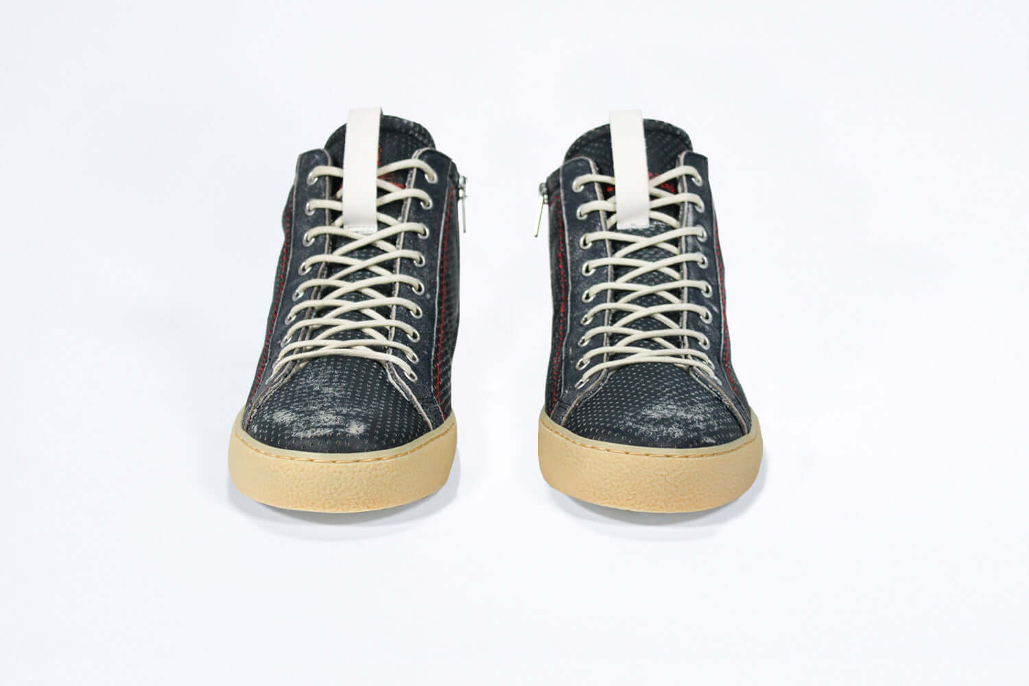 Front view of high top perforated aged navy leather sneaker with signature red stitching and a pale natural rubber sole.