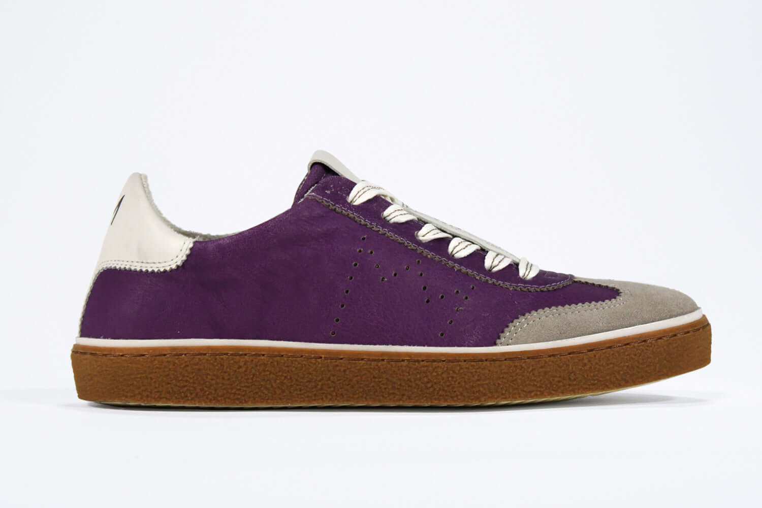 Side view of low top retro sneaker in distressed violet leather with white and grey detailing and honey coloured recycled rubber sole.