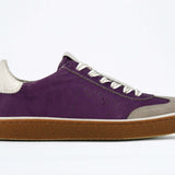 Side view of low top retro sneaker in distressed violet leather with white and grey detailing and honey coloured recycled rubber sole.