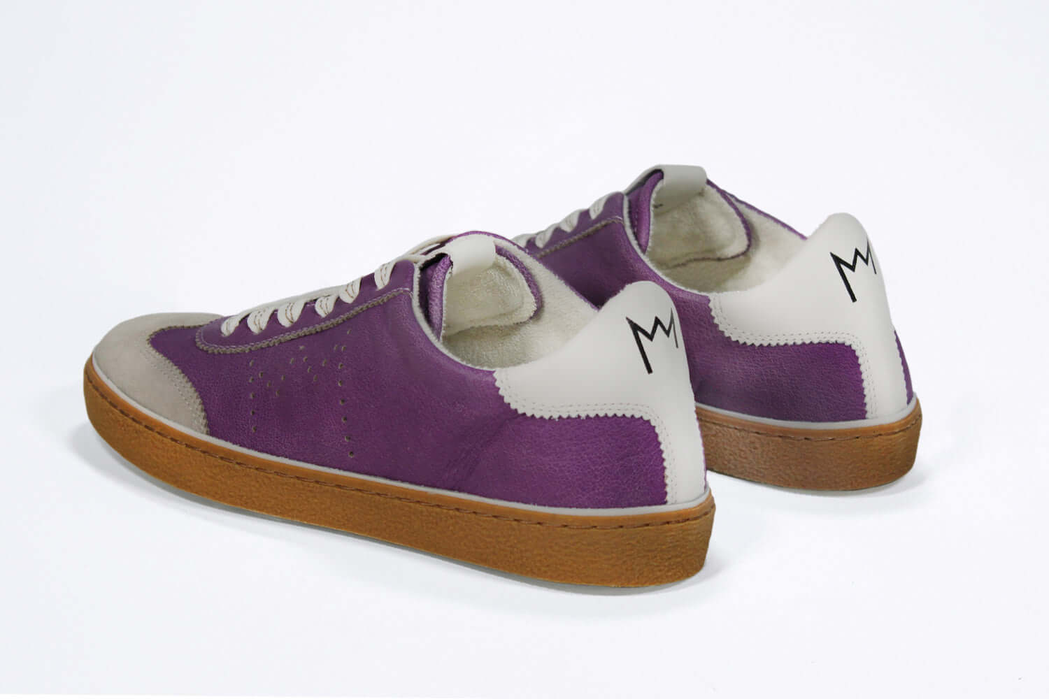 Back view of low top retro sneaker in distressed violet leather with white and grey detailing and honey coloured recycled rubber sole.
