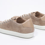 Three quarter back view of low top camel sneaker with perforated crown logo on upper. Full suede upper and white rubber sole.