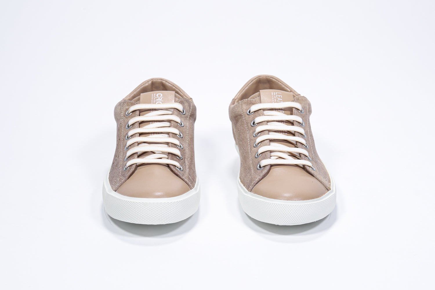 Front view of low top camel sneaker with perforated crown logo on upper. Full suede upper and white rubber sole.