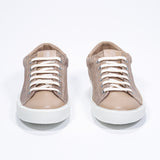 Front view of low top camel sneaker with perforated crown logo on upper. Full suede upper and white rubber sole.