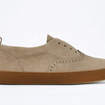 Side view of loafer style sneaker. Camel suede upper with perforated crown logo, elasticated tongue and a honey coloured recycled rubber sole.