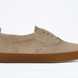 Side view of loafer style sneaker. Camel suede upper with perforated crown logo, elasticated tongue and a honey coloured recycled rubber sole.