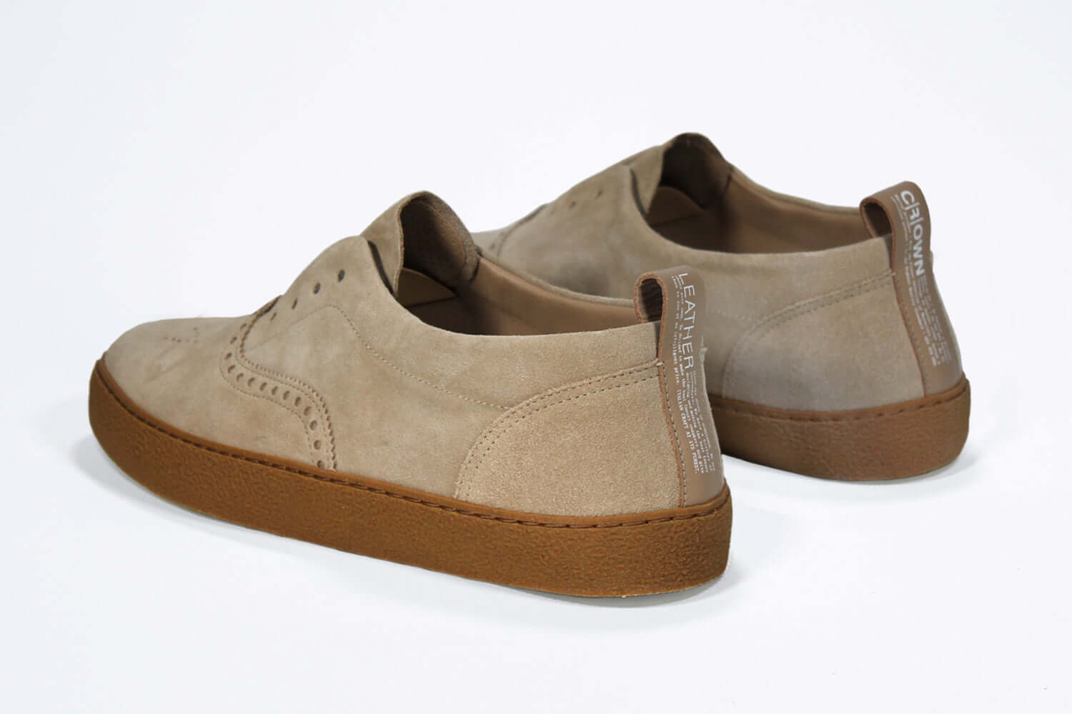 Back view of loafer style sneaker. Camel suede upper with perforated crown logo, elasticated tongue and a honey coloured recycled rubber sole.
