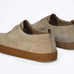 Back view of loafer style sneaker. Camel suede upper with perforated crown logo, elasticated tongue and a honey coloured recycled rubber sole.