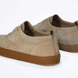 Back view of loafer style sneaker. Camel suede upper with perforated crown logo, elasticated tongue and a honey coloured recycled rubber sole.