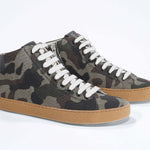 Three quarter front view of mid top camouflage print sneaker in canvas, internal zip and honey coloured sole.