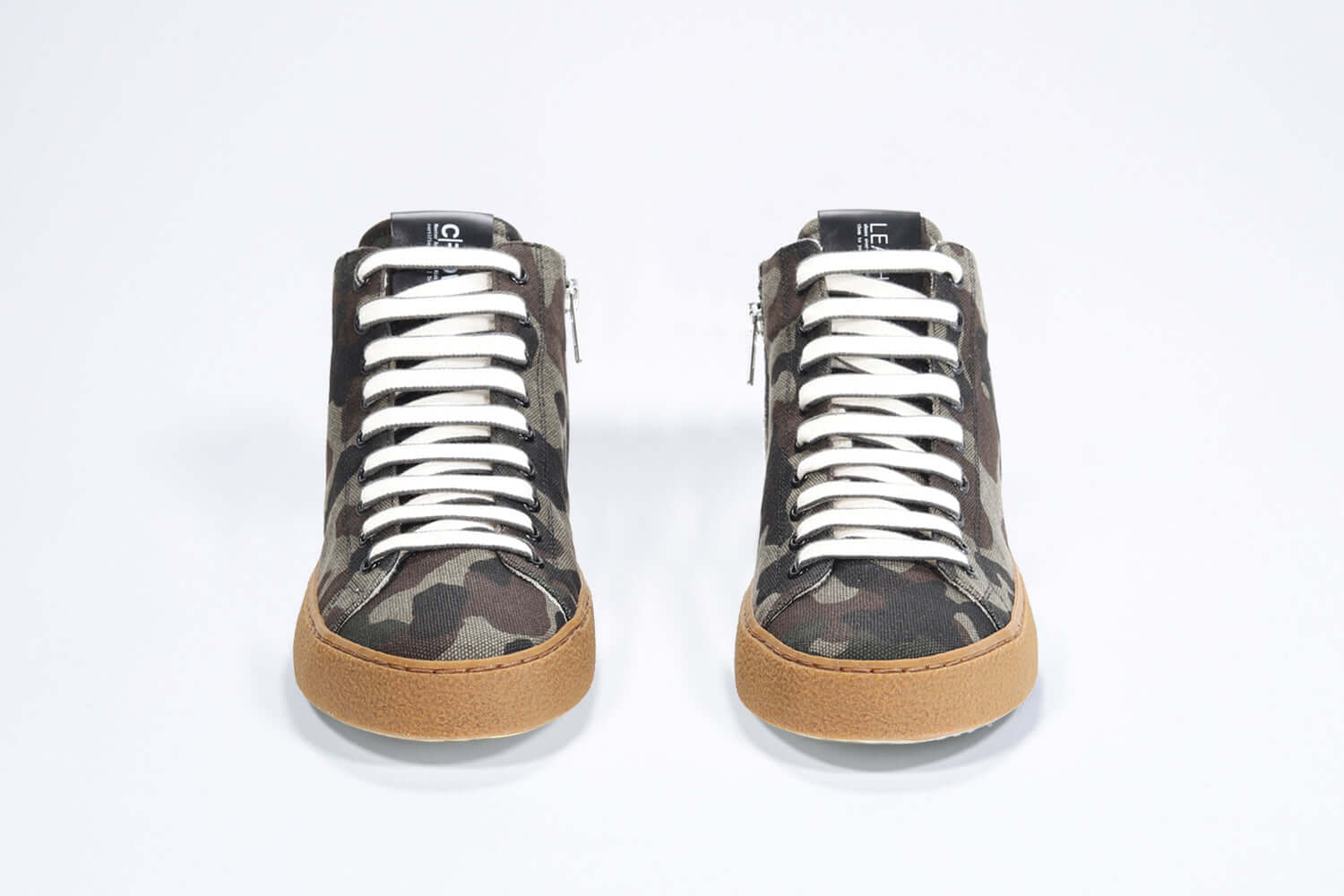 Front view of mid top camouflage print sneaker in canvas, internal zip and honey coloured sole.