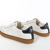 Back view of low top retro sneaker in distressed white leather with black detailing and honey coloured recycled rubber sole.