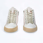 Front view of high top canvas sneaker. White canvas upper with signature red stitching and pale natural rubber sole.