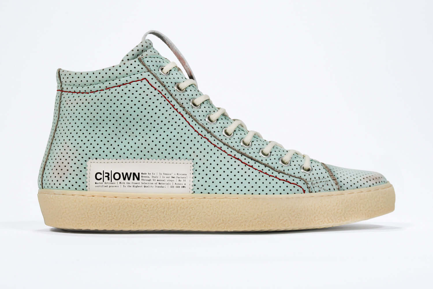 Side profile of high top sneaker. Perforated sky blue leather sneakers with signature red stitching and pale natural rubber sole.