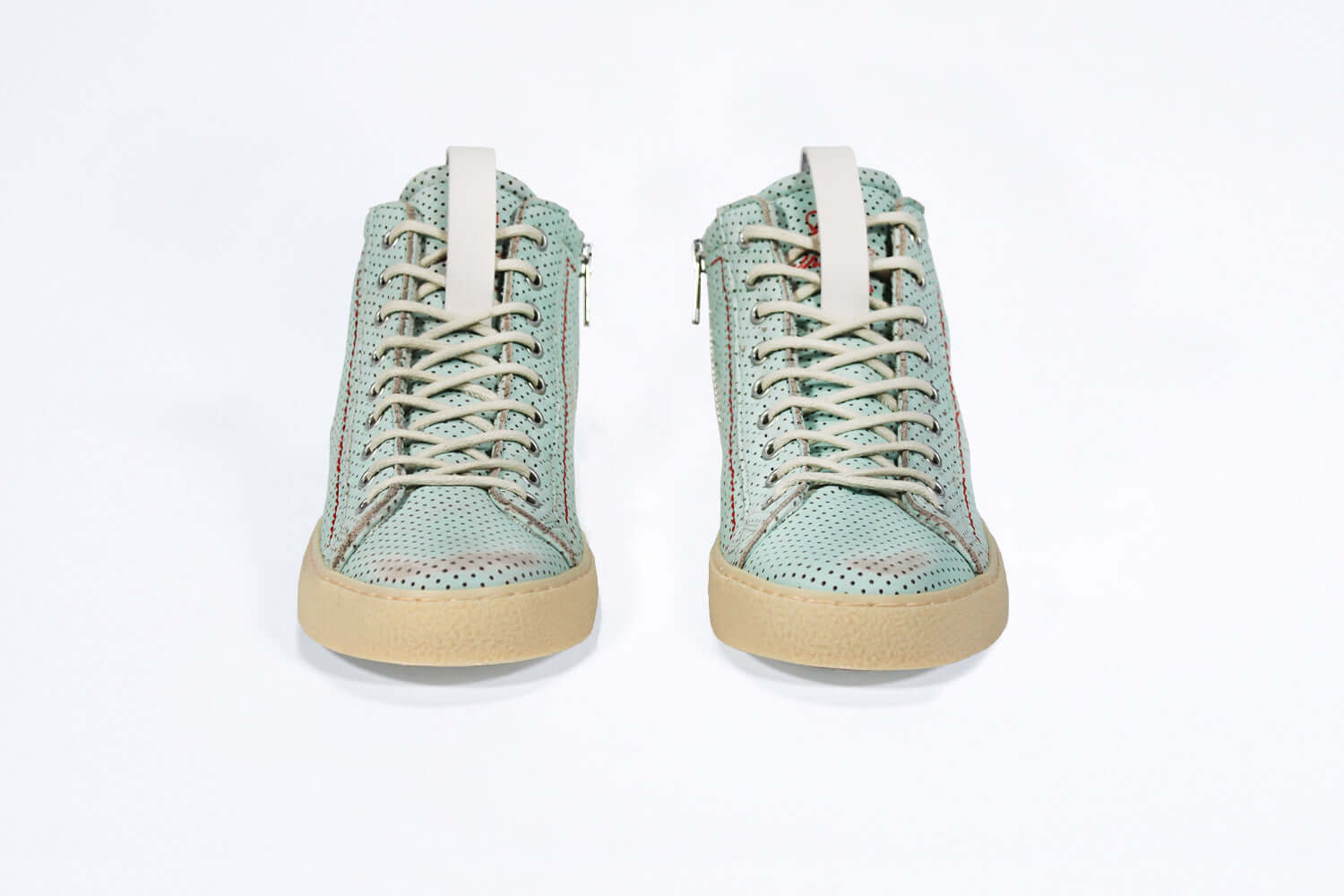 Front view of high top sneaker. Perforated sky blue leather sneakers with signature red stitching and pale natural rubber sole.