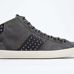 Seitenprofil von Mid Top Military Green sneaker. Obermaterial aus Wildleder und Leder mit Nieten, einem internen Reißverschluss und einer Vintage-Gummisohle.
