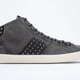 Seitenprofil von Mid Top Military Green sneaker. Obermaterial aus Wildleder und Leder mit Nieten, einem internen Reißverschluss und einer Vintage-Gummisohle.