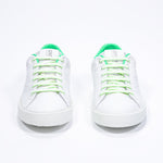 Front view of low top white sneaker with neon green detailing and perforated crown logo on upper. Full leather upper and white rubber sole.