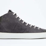 Side profile of mid top military green sneaker with full suede upper with perforated crown logo, internal zip and white sole.