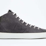 Side profile of mid top military green sneaker with full suede upper with perforated crown logo, internal zip and white sole.