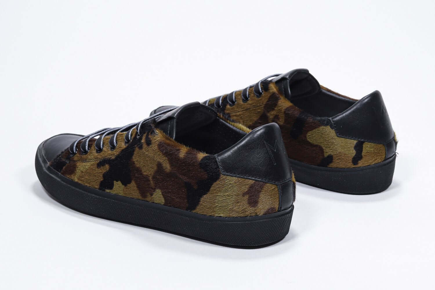 Three quarter back view of low top camouflage print sneaker. Full haircalf leather upper and black rubber sole.