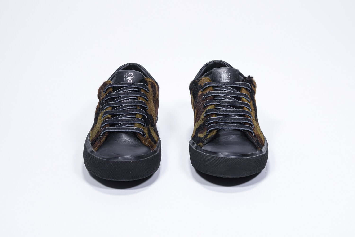 Front view of low top camouflage print sneaker. Full haircalf leather upper and black rubber sole.
