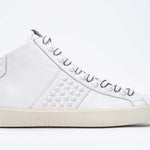 Side profile of mid top white sneaker. Full leather upper with studs, an internal zip and vintage rubber sole.