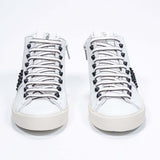 Front view of mid top white sneaker. Full leather upper with studs, an internal zip and vintage rubber sole.