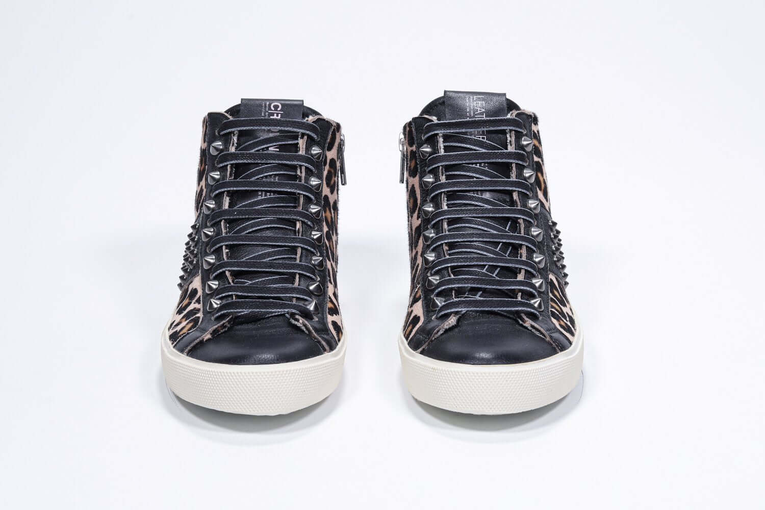 Vista frontale del mid top leopardato sneaker. Tomaia in vitello e pelle con borchie, zip interna e suola in gomma vintage.