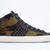 Side profile of mid top camouflage print sneaker. Haircalf and leather upper with studs, an internal zip and vintage rubber sole.