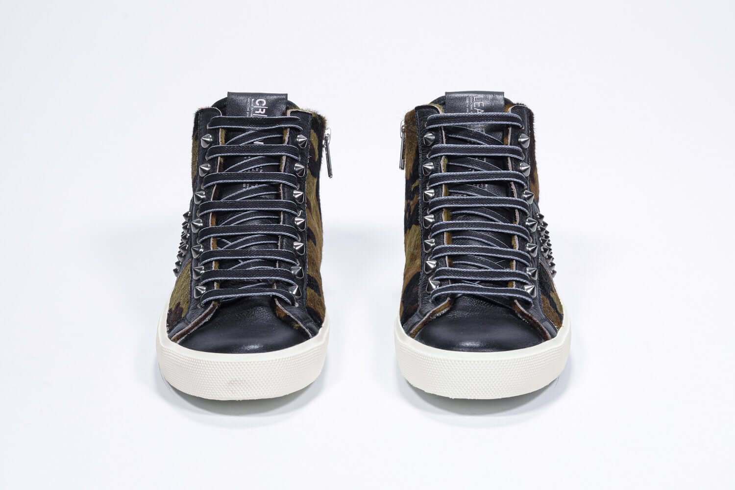 Front view of mid top camouflage print sneaker. Haircalf and leather upper with studs, an internal zip and vintage rubber sole.