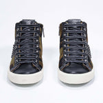 Front view of mid top camouflage print sneaker. Haircalf and leather upper with studs, an internal zip and vintage rubber sole.