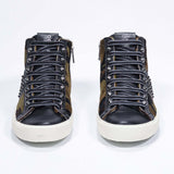 Front view of mid top camouflage print sneaker. Haircalf and leather upper with studs, an internal zip and vintage rubber sole.