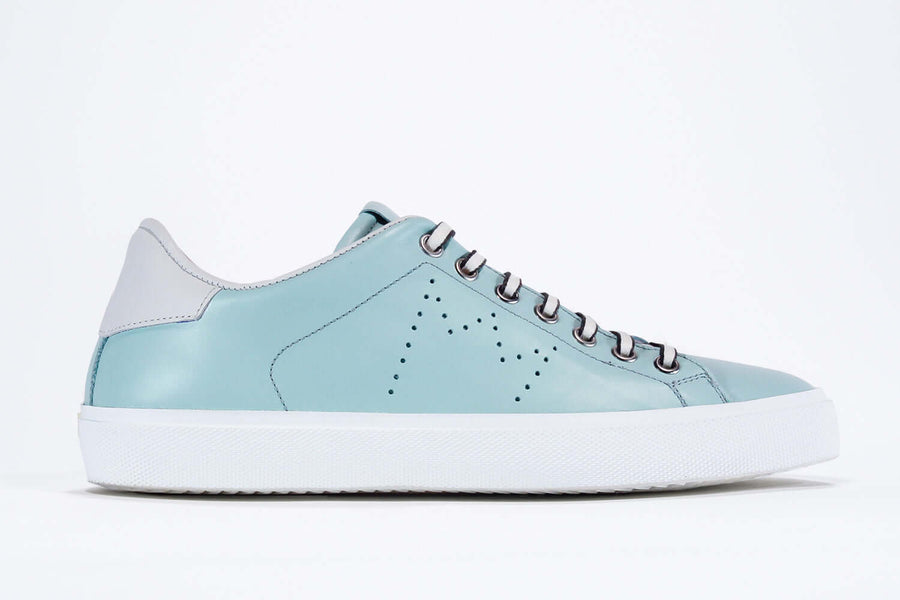 Side profile view of low top sky blue sneaker with white detailing and perforated crown logo on upper. Full leather upper and white rubber sole.
